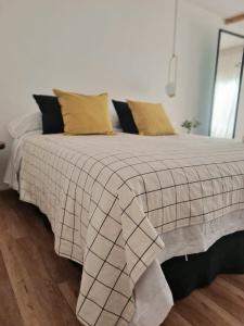 a bed with a blanket and pillows on it at Factoria - Casa de Huéspedes in Curuzú Cuatiá