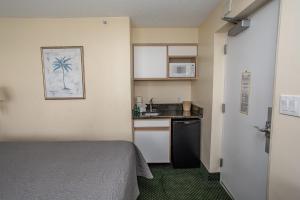 ein kleines Zimmer mit einem Bett und einer Küche in der Unterkunft Ocean View Studio King Suite Boardwalk Resort Unit 540 Sleeps 2 in Myrtle Beach