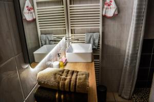 a bathroom with a sink and a mirror at Chambres et table d'hôtes Floromel La Souterraine en rez de chaussee in La Souterraine