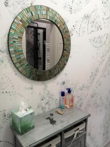 a bathroom with a mirror on a table with a sink at Hanna apartman in Szeged