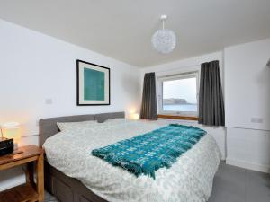 a bedroom with a large bed and a window at Generals Yard in Eyemouth