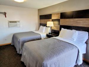 um quarto de hotel com duas camas e uma janela em Woodland Inn em Niagara Falls