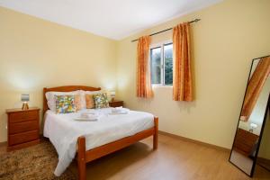a bedroom with a bed and a window at São Vicente House in São Vicente