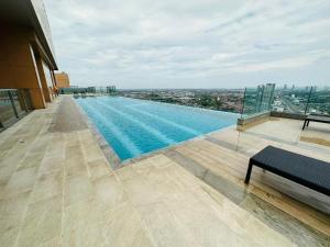 a swimming pool on the roof of a building at Plum Central Near shopping Mall @ Bangyai in Nonthaburi