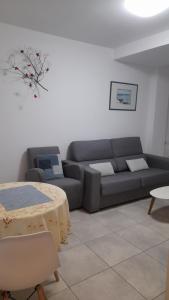 a living room with a couch and a table at Sal Mar Suites in Santa Eularia des Riu