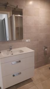 a bathroom with a white sink and a mirror at Sal Mar Suites in Santa Eularia des Riu