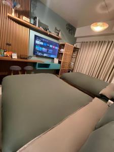 a living room with a couch and a computer monitor at Suēlo at Cool Suites at Wind Residences Tagaytay in Tagaytay
