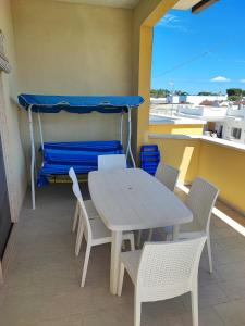 een tafel en stoelen op een balkon met een bed bij Casa Limone in San Pietro in Bevagna