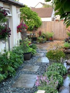 a garden with a stone walkway in front of a house at Balcony House Apartment in Kendal in Kendal