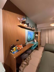 a room with a desk with stools and a bed at Suēlo at Cool Suites at Wind Residences Tagaytay in Tagaytay