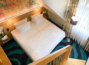 Ένα ή περισσότερα κρεβάτια σε δωμάτιο στο HKK Hotel Wernigerode