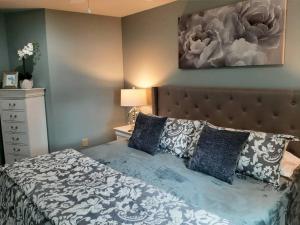 a bedroom with a large bed with blue and white sheets at 5 Star Waterfront Luxury Vacation Apartment in New London