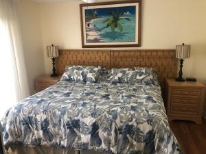 a bedroom with a bed and a painting on the wall at Florida Condos on Lake Tarpon in Palm Harbor