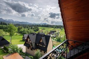 an aerial view of a house with mountains in the background at Budzowy Dworek in Murzasichle