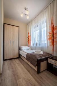 a bedroom with a bed and a large window at Budzowy Dworek in Murzasichle