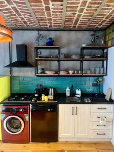 a kitchen with a stove and a washing machine at Heristage Istanbul in Istanbul