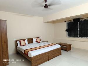 a bedroom with a bed and a window at PREMIER INN LODGE in Mangalore