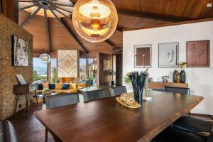 a dining room with a wooden table and a living room at Via Vallarta in Los Angeles