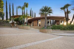 a house with palm trees in front of it at Via Vallarta in Los Angeles