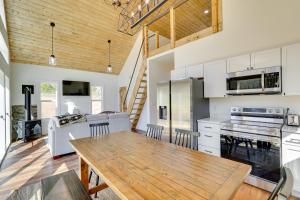 a kitchen with a wooden table and a dining room at Modern Appalachian Vacation Rental with River Access in Pennington Gap