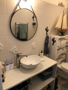 a bathroom with a sink and a mirror at Ma Mère Beach Condo Oostende in Ostend +40 photos