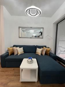 a blue couch in a living room with a table at Luxury Studio in Downtown, Free Parking & Pool in Budapest