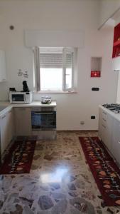 a kitchen with a stove and a microwave in it at Appartamento NINI' in Uggiano Montefusco +36 photos