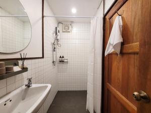 a bathroom with a sink and a mirror at Baby Come Home in Chiang Mai