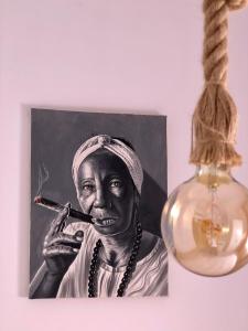 a picture of a woman smoking a cigarette next to a lamp at Apartamento La Habana Vieja in Jerez de la Frontera