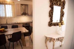 a kitchen with a table and a mirror on the wall at Mariangelas House in Kos +24 photos