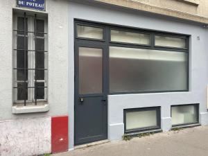 a door of a building with two windows at ZZZ poteau de Paris 4P in Paris