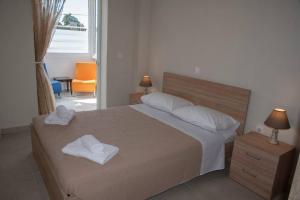 a bedroom with a bed with two towels on it at Mariangelas House in Kos