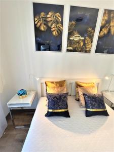 a bedroom with a bed with two pillows on it at Luxury Studio in Downtown, Free Parking & Pool in Budapest