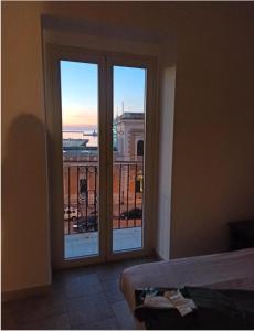 a room with a window with a view of a balcony at Cara Casa al Porto n.25 in Bari