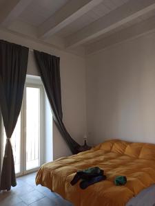 a bedroom with a bed and a large window at Cara Casa al Porto n.25 in Bari