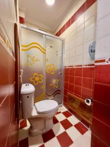 a bathroom with a toilet and a shower at Raqeem Hotel in Wadi Musa