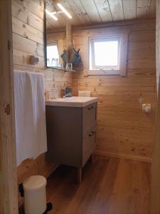 a bathroom with a sink in a wooden cabin at Cabañas by Torre de Arriba in Benimantell