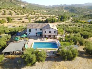 an aerial view of a house with a swimming pool at Las Marrojas, secluded Tudor country cottage in Algarinejo