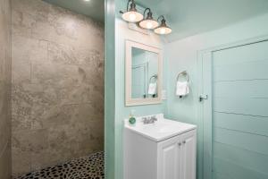 a bathroom with a sink and a mirror at Latitude 26 Waterfront Boutique Resort - Bonita Springs in Bonita Springs