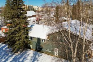 a house in the snow with snow covered roofs at Fairbanks Vacation Rental Studio Near Downtown! in Fairbanks