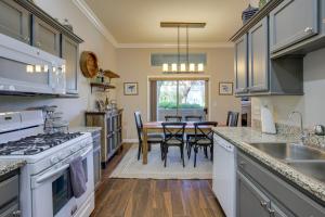a kitchen with white appliances and a table with chairs at Las Vegas Condo Rental with Pool Access! in Las Vegas