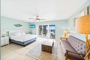 a bedroom with a bed and a couch at Sebastian Saltwater Lodge in Sebastian