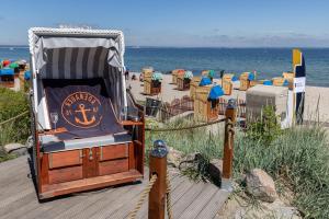 a chair with an anchor on a beach at Ferienwohnung Walther in Timmendorfer Strand
