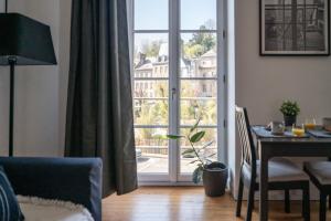a living room with a table and a sliding glass door at TAL AR PONT-MEUR in Morlaix