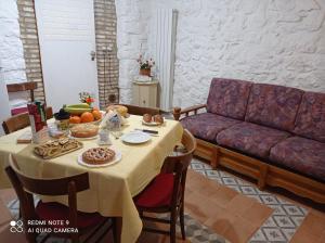 a table with food and a couch in a living room at B&B Giallo Siena in Colli al Volturno