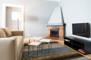 Televízia a/alebo spoločenská miestnosť v ubytovaní Apartments Rynek Glowny
