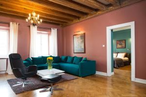 a living room filled with furniture and a couch at Apartments Rynek Glowny in Krakow