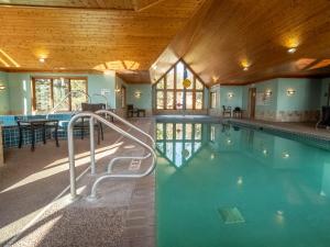 a swimming pool in a house with a wooden ceiling at Lutsen Sea Villas in Lutsen
