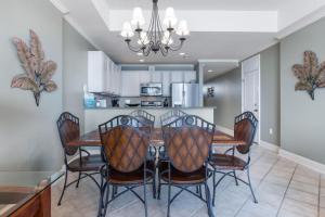 a kitchen and dining room with a table and chairs at Levins Bend at The Wharf in Orange Beach