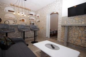 a living room with a bar with a fireplace at Apartments D in Premantura